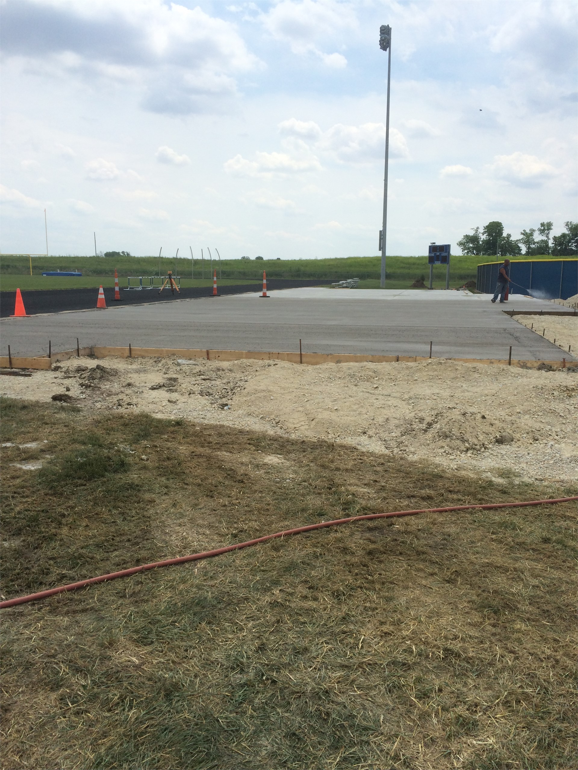Pouring concrete pad for bleachers.