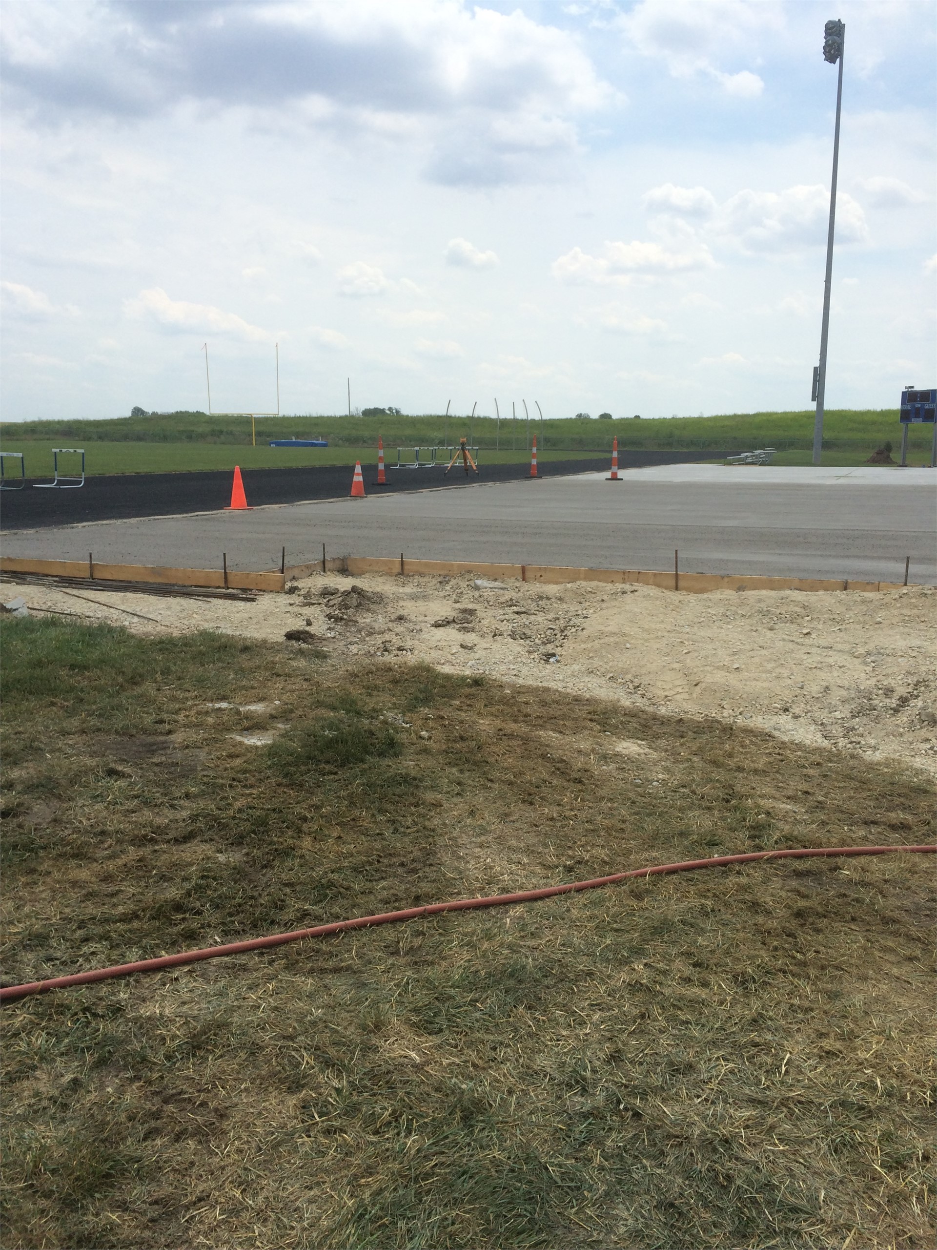 Pouring concrete pad for bleachers.