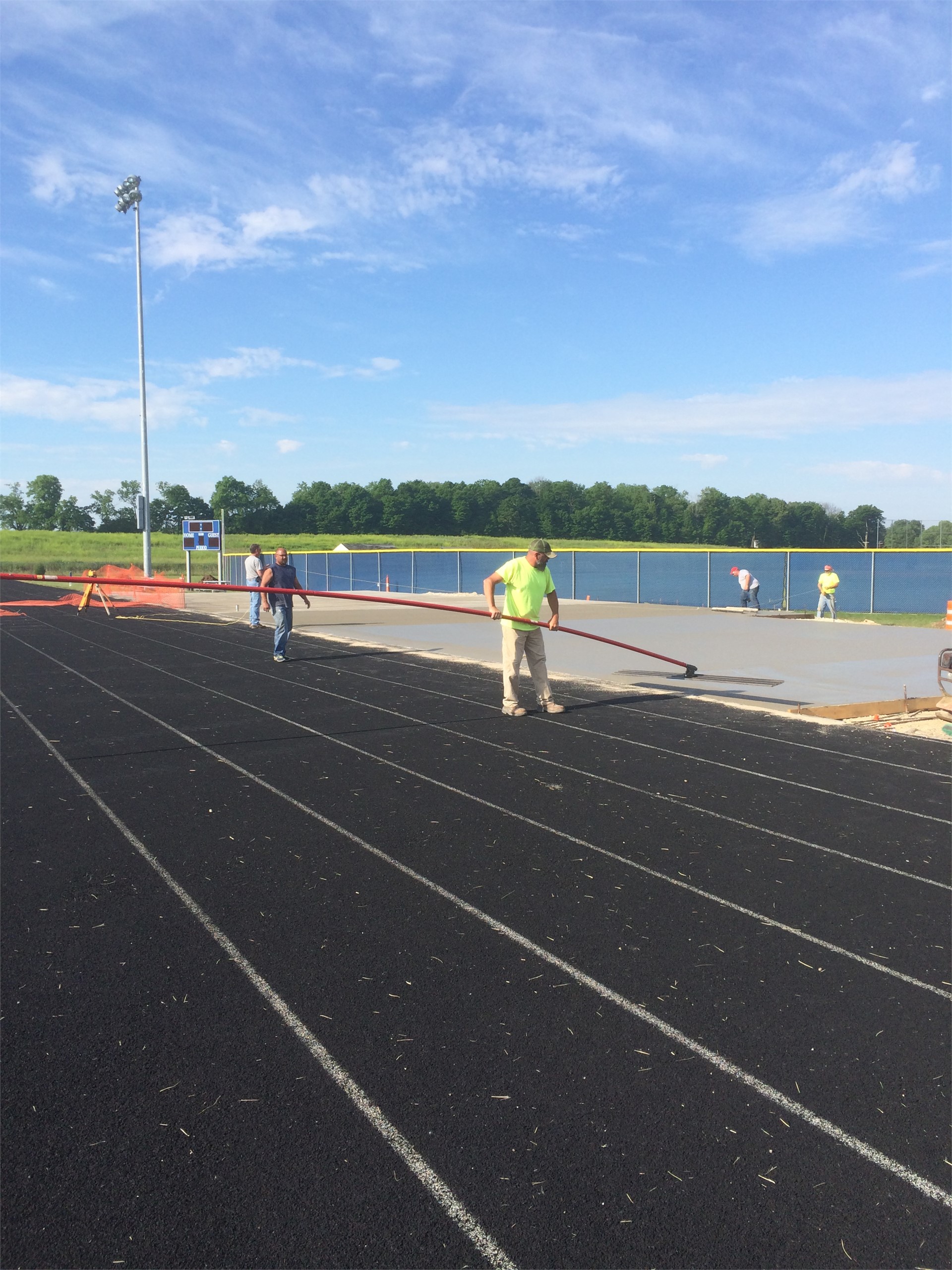 Pouring concrete pad for bleachers.